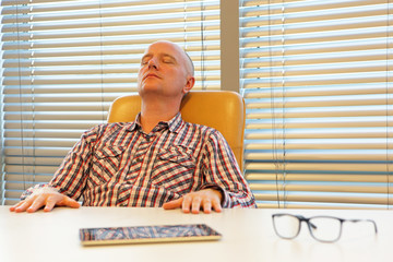 middle age balding man  relaxing in office - short break for regeneration