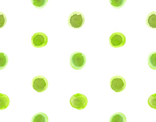 Seamless pattern with green polka dots painted in watercolor on white isolated background