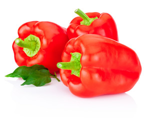 Three red peppers with leaf isolated on white background