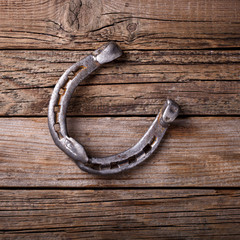 Horseshoe metal Vintage Weathered Wooden Background.Copy space. selective focus.