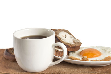 cooked fried eggs with toasted bread and hot tea
