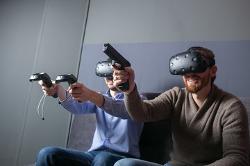 two Young man playing video games virtual reality glasses in apa - obrazy, fototapety, plakaty