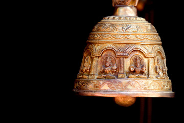Antique bell against black background