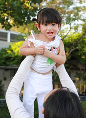 Obraz premium Asian family, Mother holding her baby was laughing in park