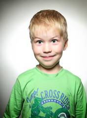 Small boy with green shirt smilling