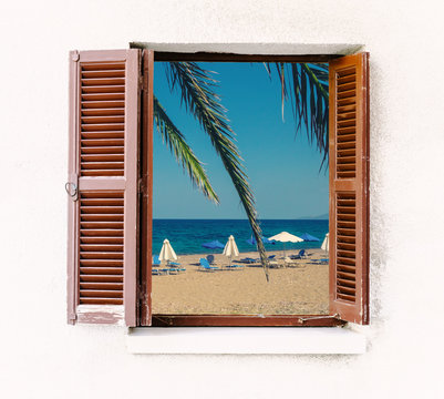 Open Window Of The Old House With Brown Wooden Shutters And Seaside View. Summer Beach - Look Out Through The Window Frame For Your Idea Of Sea Vacation. Window With Retro Blinds In Colonial Style.