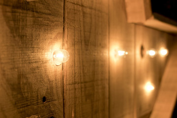 Small lights in a row on a wooden surface.