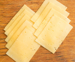 Sliced Cheese Over Rustic Wooden Background
