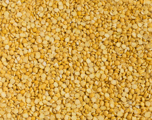 Dry Split Yellow Peas Scattered on Old Wooden Cutting Board