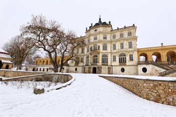 Fototapeta na wymiar Ploskovice castle with leafless trees in the winter