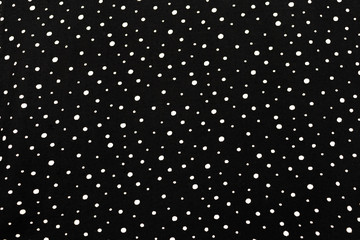 White dot on black fabric texture background