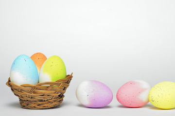 Basket of easter eggs isolated on white background