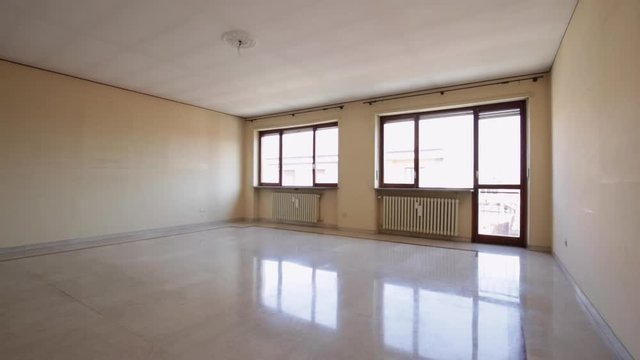 Large, empty living room with marble floor