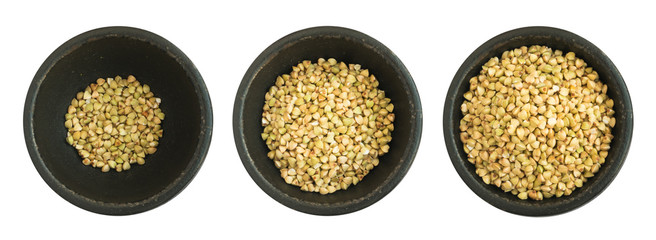 Dry Green Buckwheat Grain in Round Black Bowls Isolated