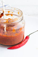 Tomato sauce with chili on a white plate
