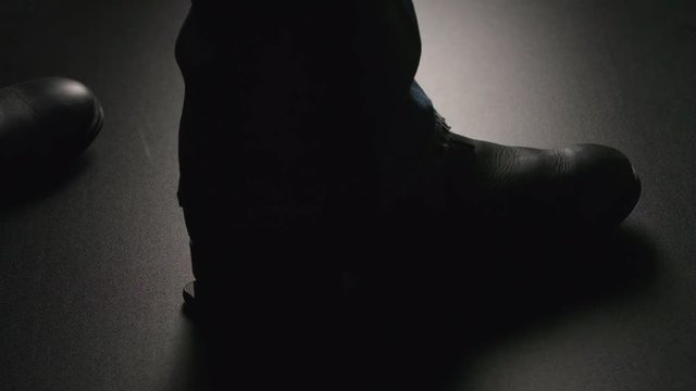 SLOW MOTION: Man crushes a smartphone on a floor by a boot