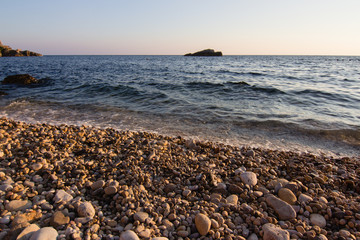 Landscape ofsSunset on the rocky sea beach