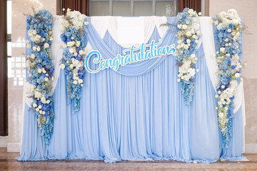 Congratulation sign on the photo shooting corner decorated with blue flowers, blue theme