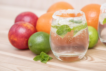 Cold fresh lemonade drink on a wooden background
