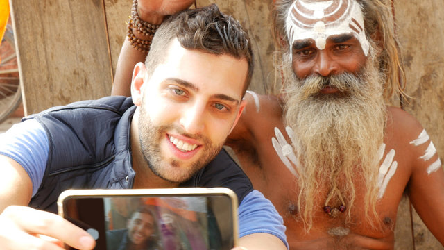 Tourist taking a selfie with Sadhu - Holy Man, in Varanasi, India