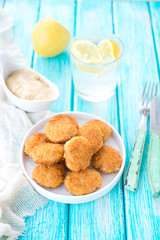 Home-made chicken nuggets on a wooden background
