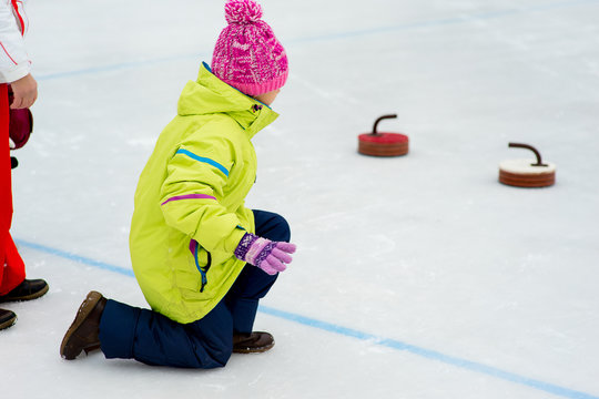 Young girls playing curling
