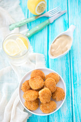 Home-made chicken nuggets on a wooden background
