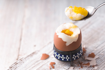 Soft-boiled egg on the white wooden table horizontal