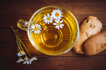 Herbal tea with cookies on the wooden table