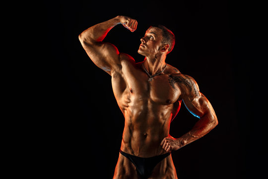 shirtless man with muscular topless body holding arm up. Isolated.