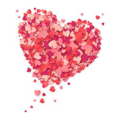 Flying heart made from pink and red confetti on white background