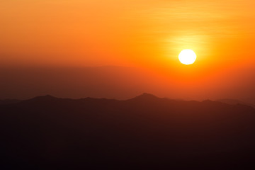 Obraz premium Sunset at the Mountain Hill,Beautiful sunlight, Orange lights background