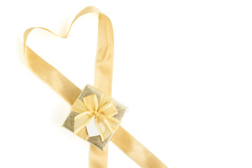 Isolated gold gift box with gold ribbon