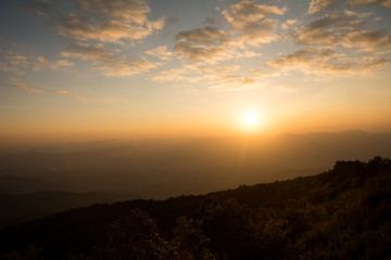 Obraz premium Sunset at the Mountain Hill,Beautiful sunlight, Golden lights background