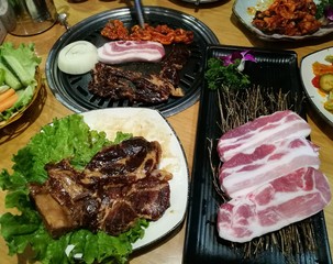 Grill pork slice on the hot BBQ pan, family dinner time, Korea food, yakiniku, Korea restaurant