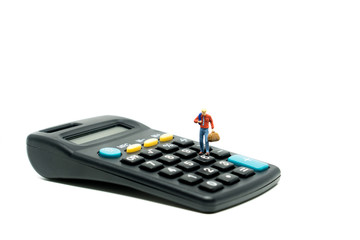 Miniature people businessman on calculator
