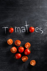 Fototapeta na wymiar Image of cut tomatoes over dark background