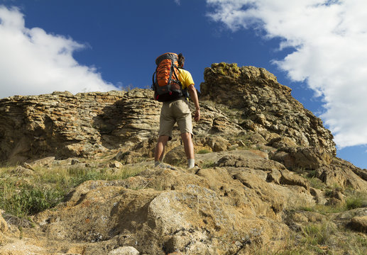  Hiking in the summer,  young man with a backpack