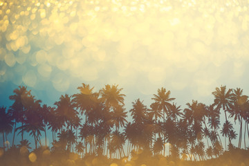 Naklejka premium Palm trees on tropical beach, vintage toned and retro color stylized with shiny party glitter overlay effect