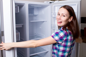 Fototapeta na wymiar female teenager looking in empty refrigerator