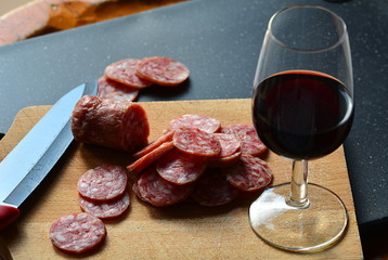 Italian antipasto: homemade salami and glass of red wine.