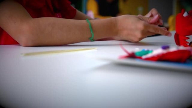 Little girl playing dough at school