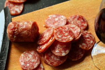 Italian antipasto: homemade salami and glass of red wine.
