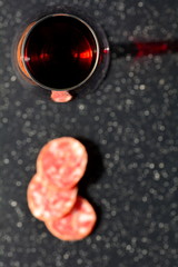 Italian antipasto: homemade salami and glass of red wine.