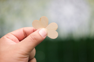 Wood hearts in hand, Valentine's day.