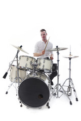 Fototapeta na wymiar drummer behind drum set wears white shirt and plays the drums