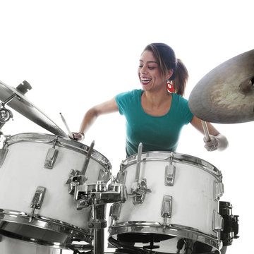 brunette brazilian woman plays the drums in studio