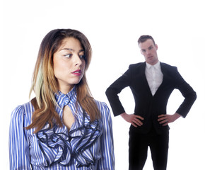 female subordinate in thought while male boss stands in backgrou