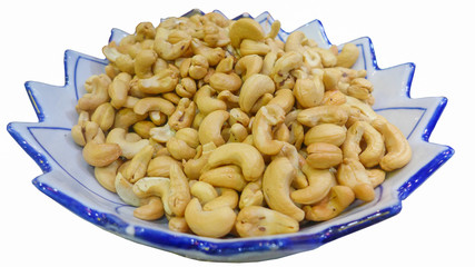 Cashews in the plate on the white background