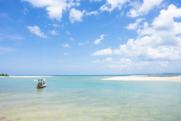fishing boat on the seascape and cloud in blue sky at asia beach